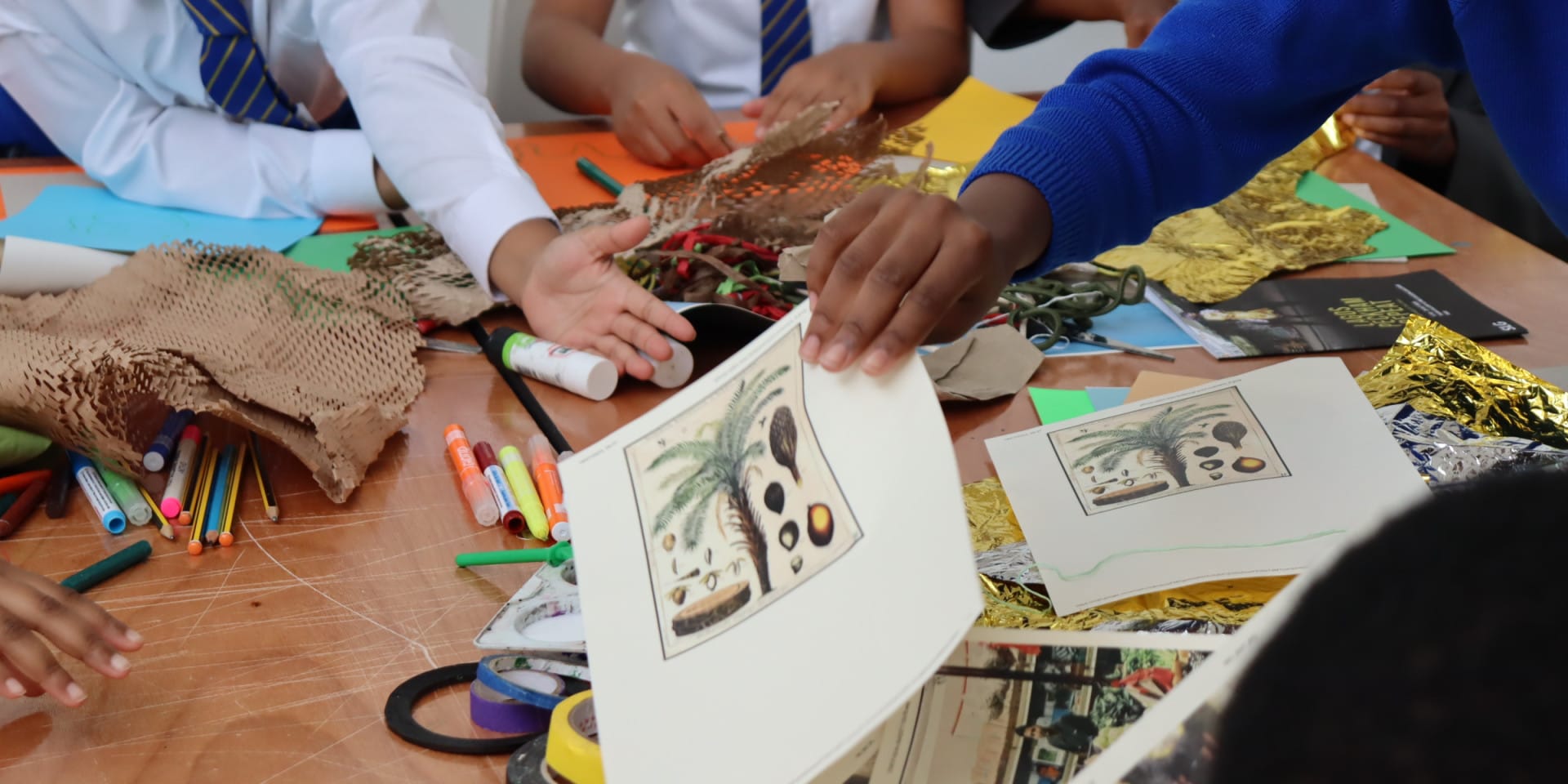 School children engaging with creative materials